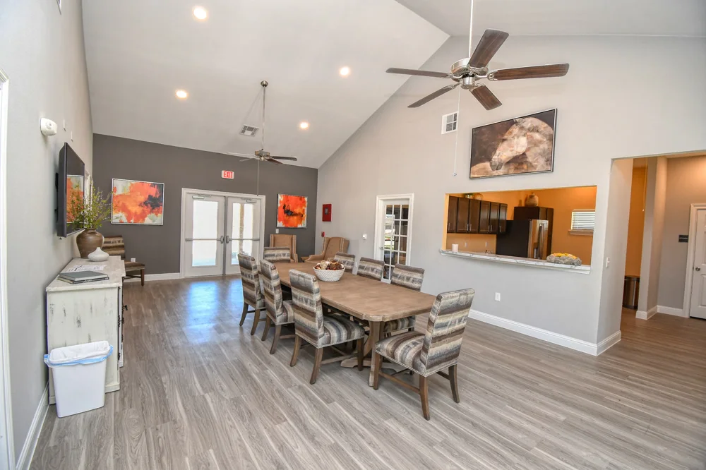 Light-filled community room with seating and catering kitchen